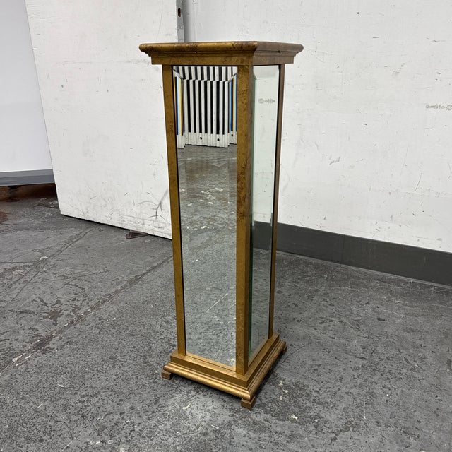 Design Plus Gallery presents a Mirrored Pedestal. A striking pedestal column, expertly crafted from a sturdy metal frame...