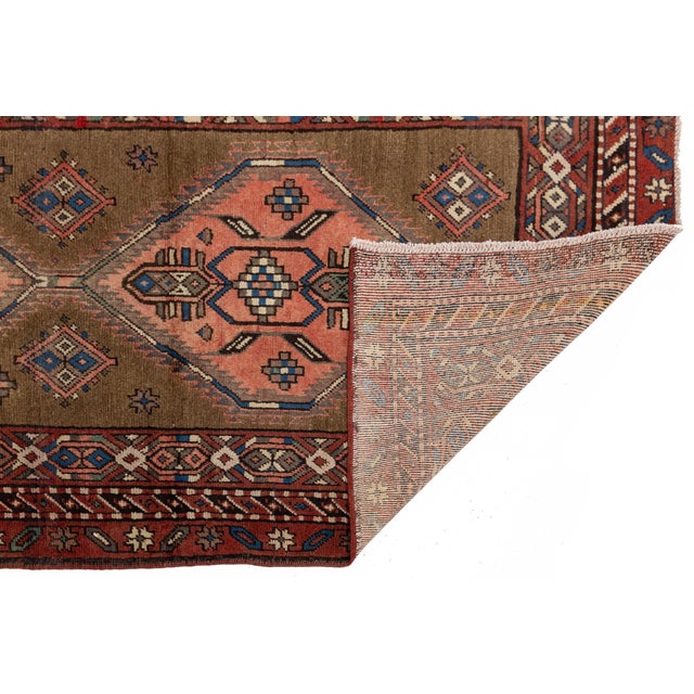 Elevate your interiors with this exceptional mid-20th century hand-knotted vintage Turkish Anatolian runner rug, expertly...
