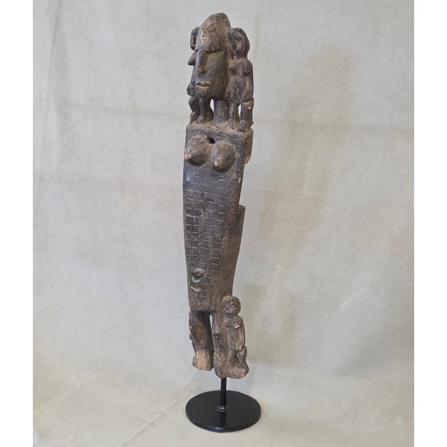 A unique old carved wood door latch that was created by the Dogon people in Mali, Africa. At some point in time it was...