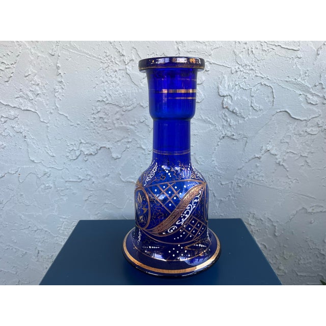 This striking vintage Bohemian glass vase features deep cobalt-blue glass richly decorated with hand-applied enamel and...