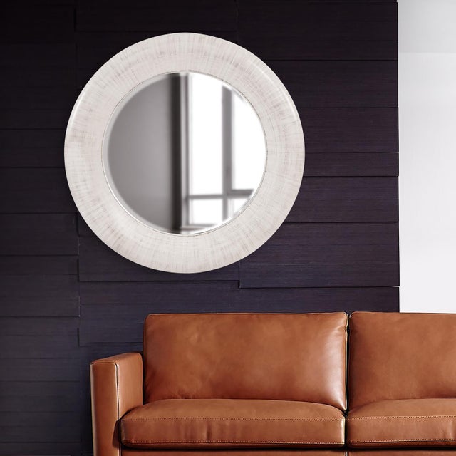 Our Jareth Mirror features a large, oversized round frame. It is finished in an ivory white, decorated with soft black...