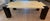 An Armani Casa dining table with goatskin parchment top over black lacquered wooden legs with brass detailing, made in...