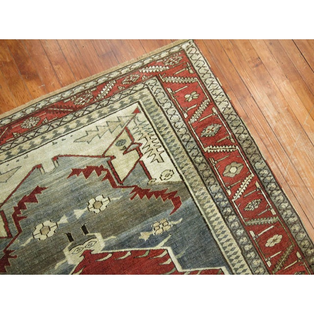 An early 20th century fine quality Persian Serapi rug. Predominantly grey, rust, and brown. On both ends of the central...