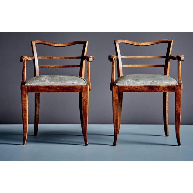 Pair of 1930s French armchairs with serpentine top rails, ladder-back splats and gracefully curved S-shaped armrests on...