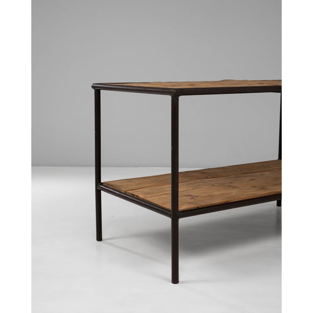 This 20th Century French industrial wooden table on a metal base combines functional simplicity with a warm, time-worn...