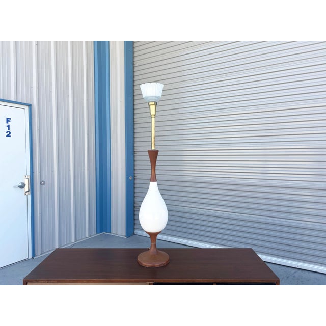 Mid-Century Modern Tall Sculptural Walnut & Ceramic Table Lamp designed and manufactured in the United States, circa...