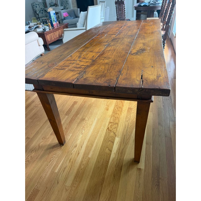 Beautiful 19th-century American primitive harvest table with exceptional character and a richly patinated solid wood plank...