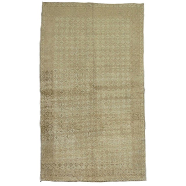 A handmade mid-century Turkish weave in khaki and taupes. Measures: 4'3'' x 6'8''.