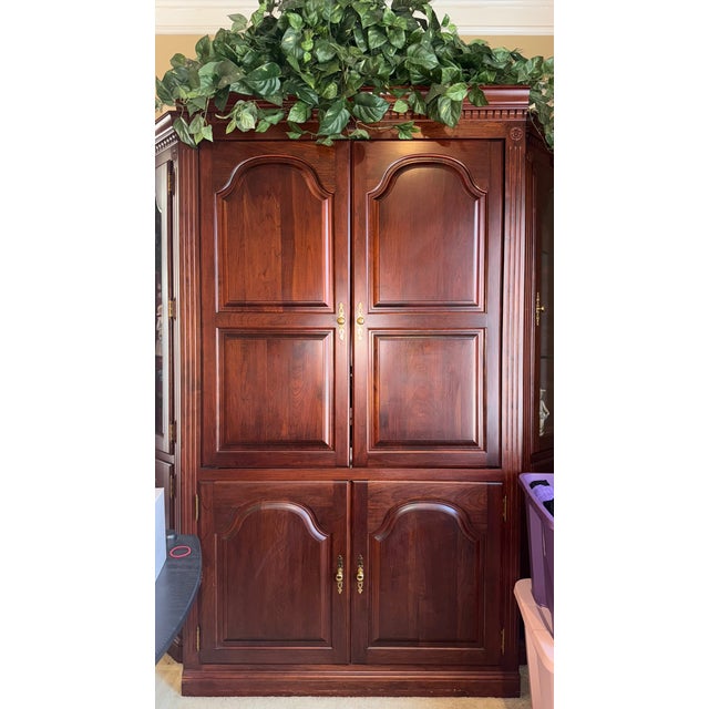 Beautiful, well-kept solid cherry entertainment armoire with two matching glass-front curio cabinets. This is a high-...