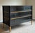 Elegant and highly sophisticated Baker three-drawer chest featuring a dramatic black lacquered finish accented with gilt...