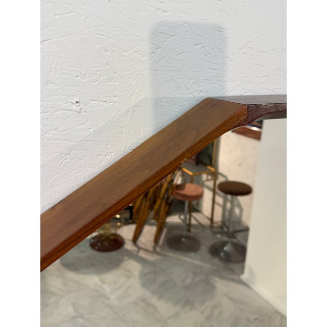 A bold and geometric Italian mirror from the 1990s, distinguished by its large dodecagonal form and richly grained walnut...