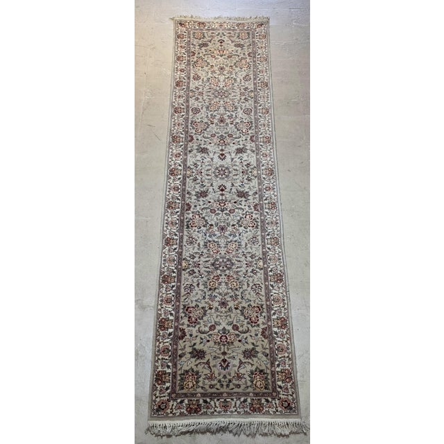 Tabriz-runner rug featuring an intricate allover floral design in a soft ivory and light beige field, accented with muted...