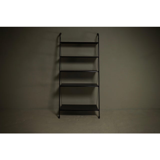 Shelving unit from the 1990s. The piece has two steel uprights and distinctive perforated steel shelves. The design...