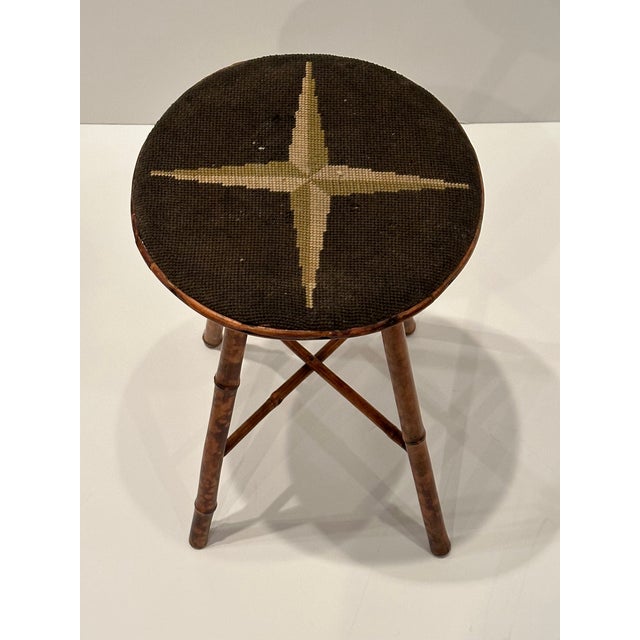 Classic American vintage bamboo stool having original needlepoint seat.