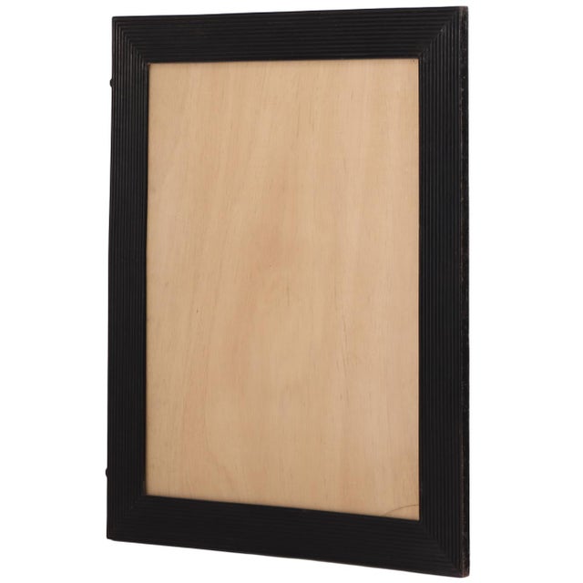 Executed in the bold neoclassical style characteristic of the Empire period, the architectural frame features clean lines...