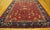 Antique Chinese Art Deco rug with a red background and navy border.