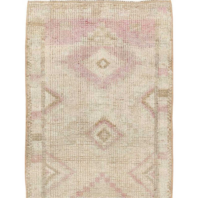This mid-20th-century Turkish Anatolian runner presents a softly articulated sequence of geometric medallions across a...