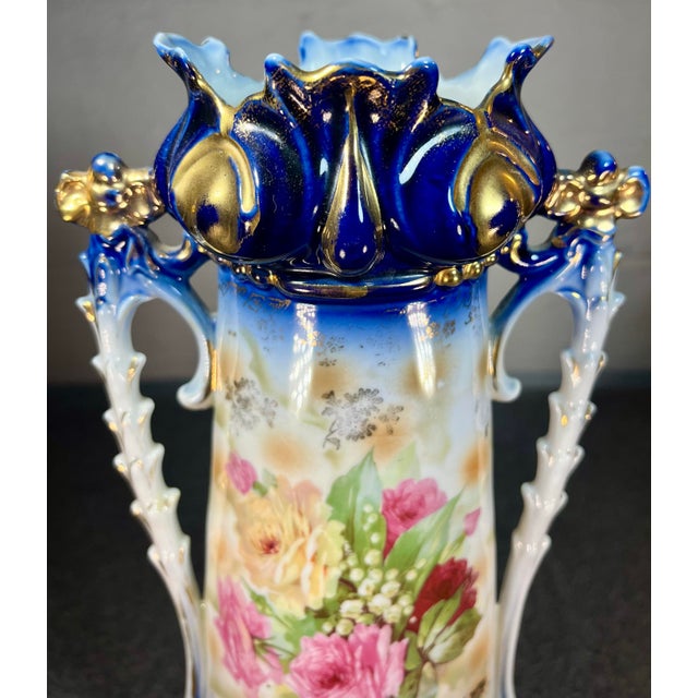 Very fine, detailed porcelain vase unmarked from Germany. White and cobalt blue with a luster finish, floral decor, and...