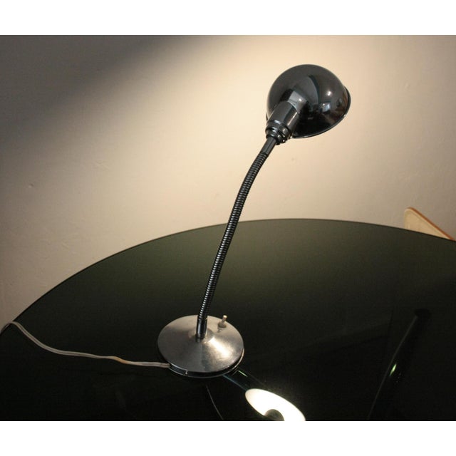 Vintage 1960s table lamp, chromed metal, round base with cast iron weight and flexible/adjustable neck. It was most likely...