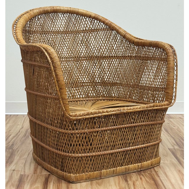 Vintage wicker rattan Buri chair with a barrel-shaped silhouette and intricate woven wicker. Pretty starburst spiral...