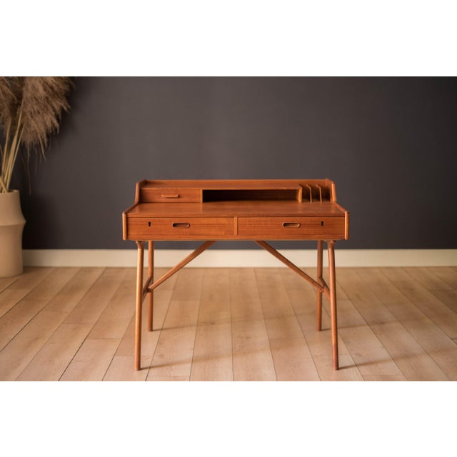 Vintage Danish writing desk in teak designed by Arne Wahl Iversen for Vinde Møbelfabrik, Denmark. This versatile piece...