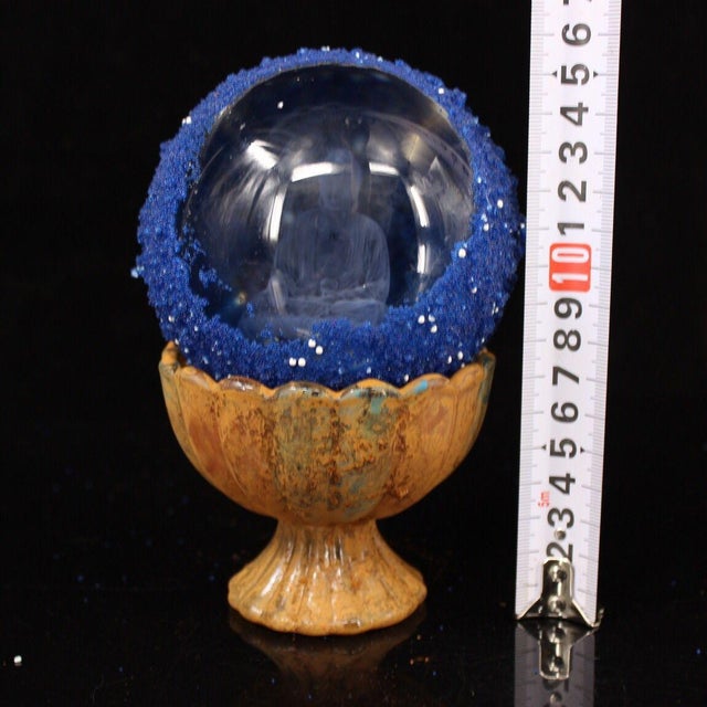 This is a rare and unusual Buddhist relic sphere, described as a "regenerated sarira" containing an etched image of a...