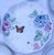Hand painted hydrangeas, roses, and other garden flowers in lovely pinks, blues, and yellows create a virtual garden for...