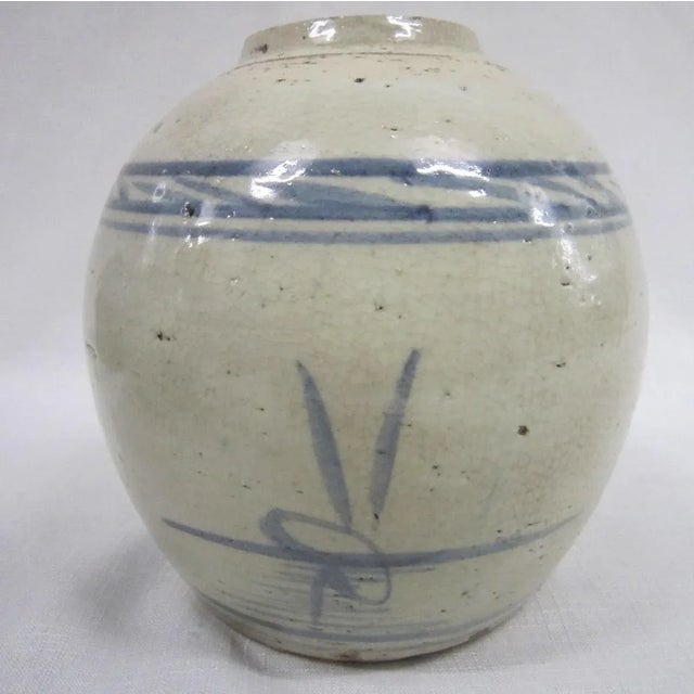 Early Chinese pottery brush pot with iconic blue and white design. In excellent condition, with crackle glaze. It measures...