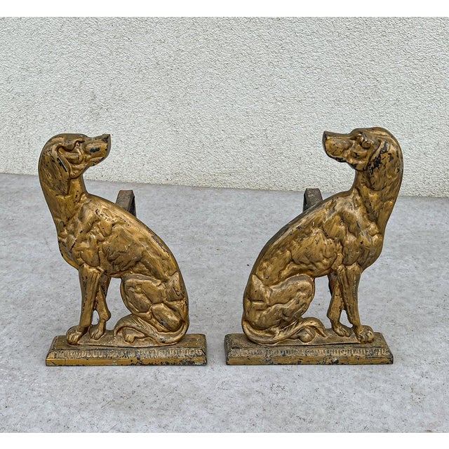 Antique bronze andirons, originating from France in the 1930s. They are crafted in the shape of seated dogs, very...