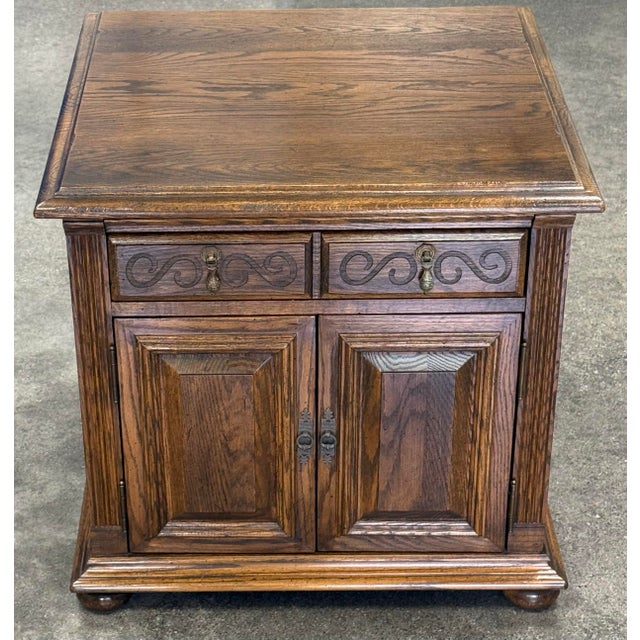 Beautiful solid oak jacobean nightstand by Ethan Allen from their “Royal charter” collection. Features a storage cabinet...