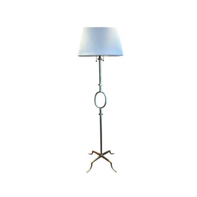 This gorgeous vintage iron floor lamp attributed to Gilbert Poillerat by Mattaliano with gilt finish is in excellent...