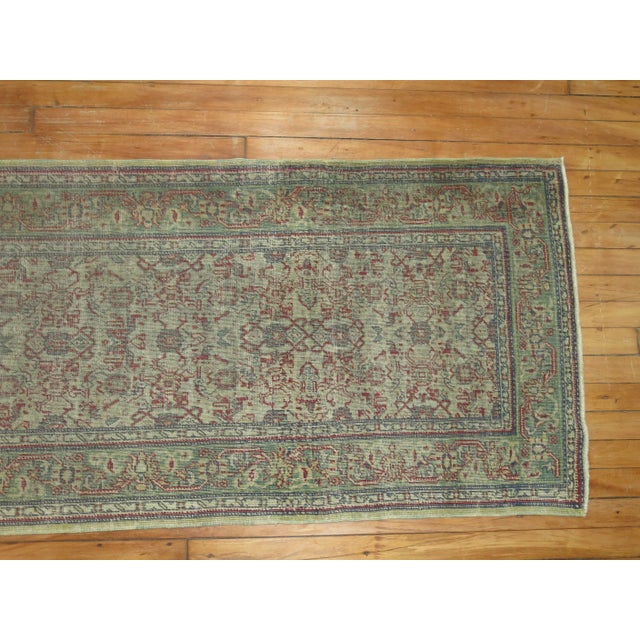 A 19th Century worn turkish runner with an all-over design on a gray field. Professionally Cleaned and able to endure...