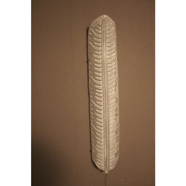 This very elegant pair of Murano glass sconces has got feather shape and features 2 nuances of white glass. It gives a...