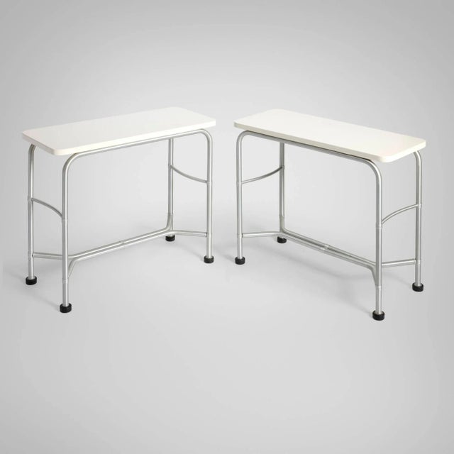 Warren McArthur Pair of Console Tables Warren McArthur Corporation, c. 1933 Aluminum frame with painted wood tops and...