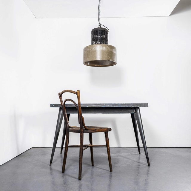 1970's large holophane industrial pendant lamps with grill top. Holophane was founded in france in the late 19th century...