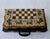 A one-of-one luxury chess and backgammon set, hand-painted with an animated polo scene surrounding the chess board. Riders...