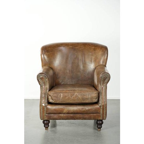 We are offering this charming, rugged cowhide armchair in a lovely, compact size with a beautiful patina. This amazing...