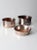 This is a set of three antique copper basin bowls. The hammered copper bowls feature lipped rims and etched stripes on...