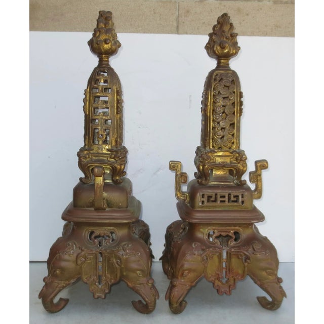 Fine cast French bronze Chinoiserie garnitures in the form of incense burners with highly stylized ventilation mounts....