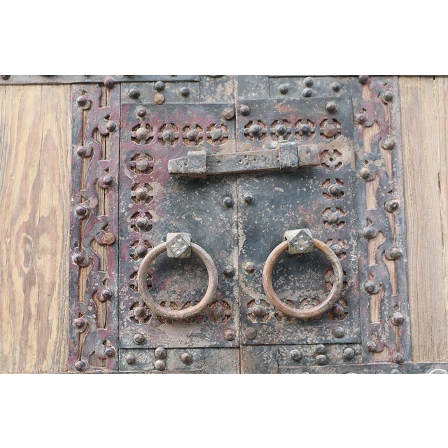 Antique Chinese Pine Compound Gate, of monumental proportions featuring iron strapping with nailheads and a very...