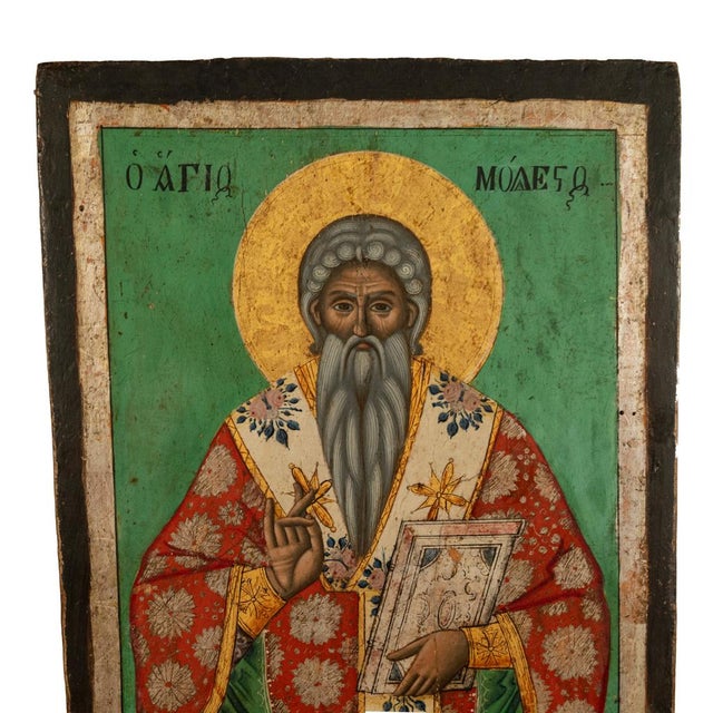 A fine antique hand-painted and gilded Greek Orthodox icon, of Saint Modestos, circa 1800. The icon is hand-painted with...