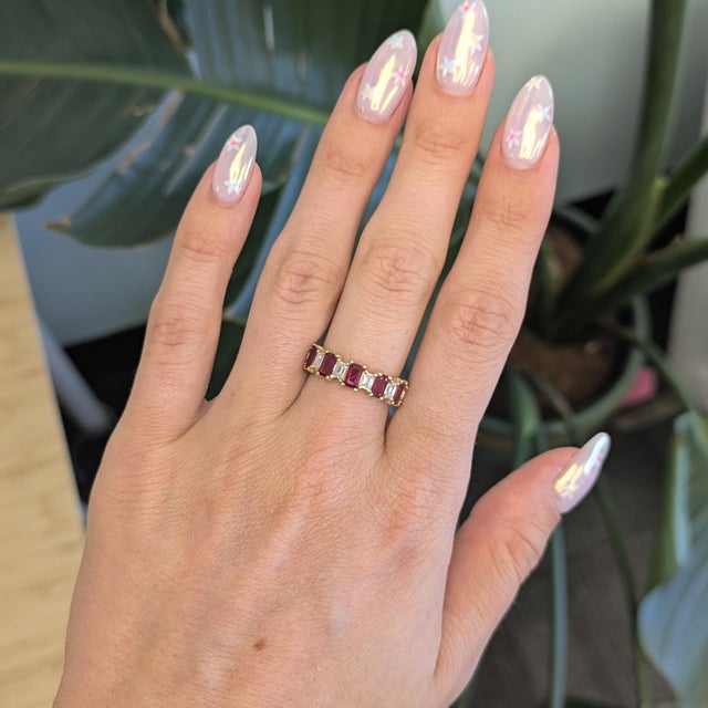 Elegant ruby and natural diamond band ring featuring a beautifully balanced design that combines the rich, passionate red...