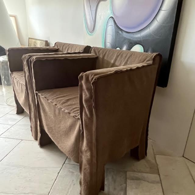 Two Summer Armchairs by Baxter. Made in Italy & designed by Paola Navone Embossed sueded leather slip covers that have the...