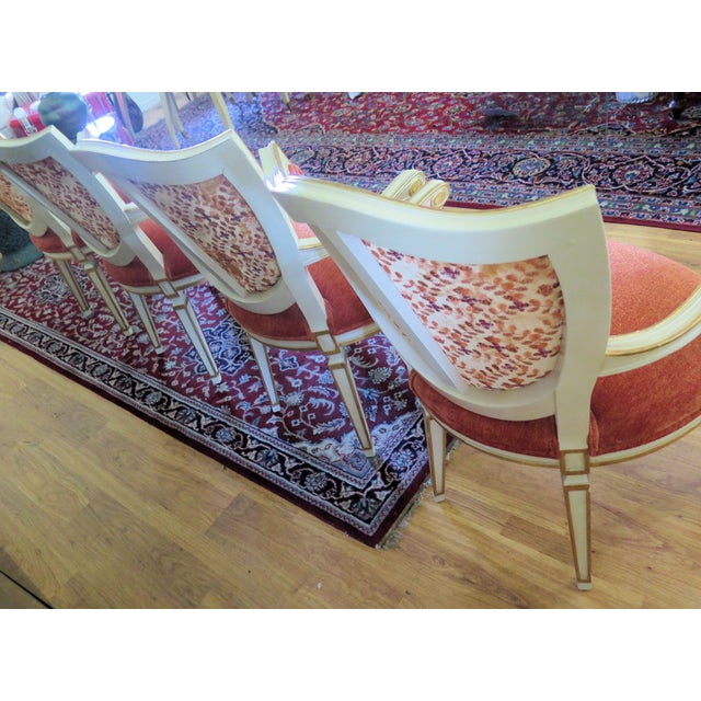 William Switzer Louis XVI Fauteuils arm chairs are white and gold leaf hand carved chairs. The front seats and backs of...