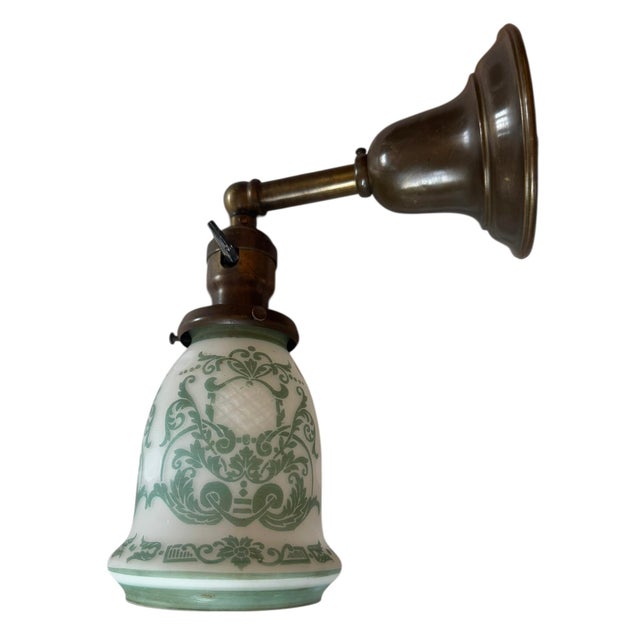 The perfect sconce to add big charm in any room of the house. The white cased glass with green etched damask design is...