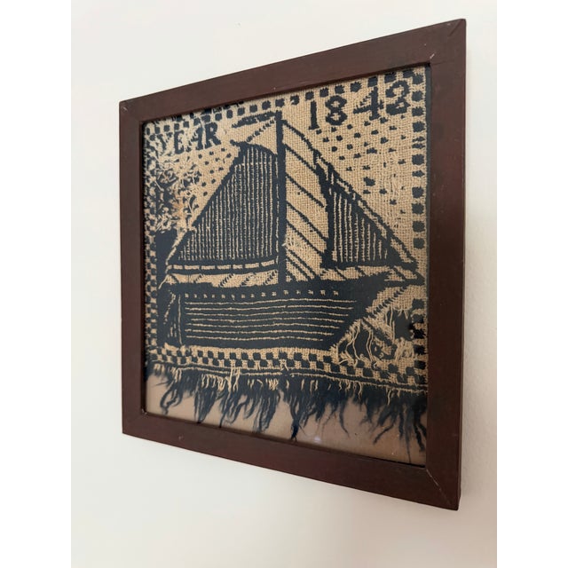 This is a charming vintage nautical textile fragment art piece, featuring a stylized sailing ship woven in a graphic navy...