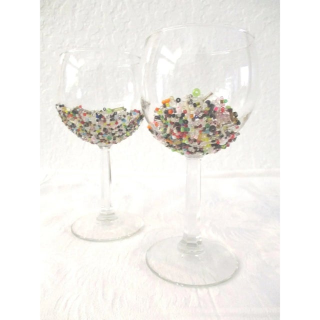 Pretty set of eight clear stemmed wine glasses featuring colorful abstract, multi-shaded, bead-encrusted bowls. Beads set...