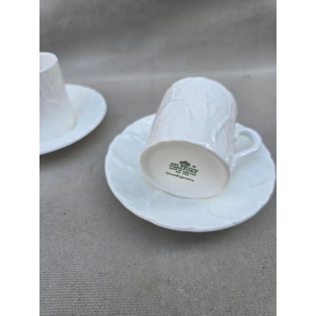 A pair of rare demitasse cups and saucers from the legendary Coalport collection. They have the distinct embossed cabbage...