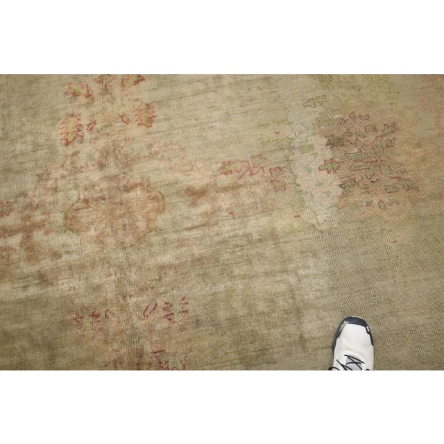 A large size late 19th-century antique Turkish Oushak rug with a silvery gray field, accents in green, gold, and...