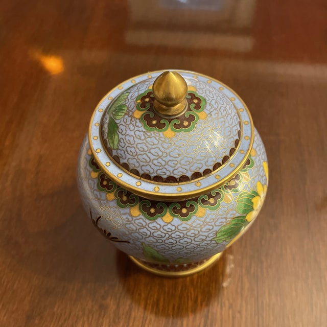Asian Cloisonné Petite Ginger Jar with sky blue ground featuring intricate brass coil designs of clouds, birds and flowers...